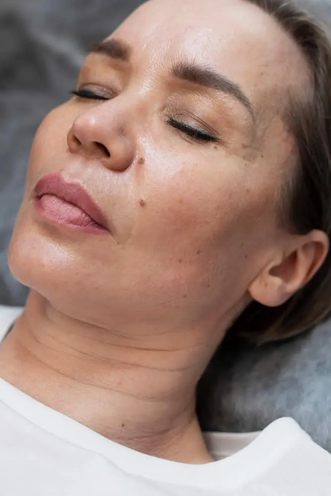 happy mature woman high-angle-woman-getting-microliposuction-treatment